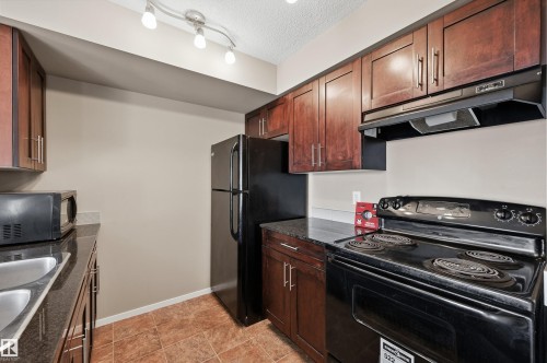 208 5810 Mullen Place, Edmonton, AB - Indoor Photo Showing Kitchen With Double Sink