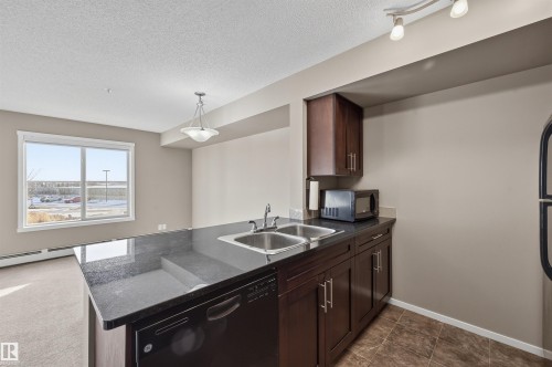 208 5810 Mullen Place, Edmonton, AB - Indoor Photo Showing Kitchen With Double Sink