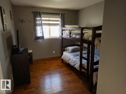 Bedroom featuring dark wood-style floors - 