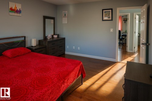 Bedroom with hardwood / wood-style flooring and baseboards - 4 4350 23 Street, Edmonton, AB - Indoor Photo Showing Bedroom