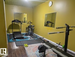 Exercise room with dark wood finished floors - 