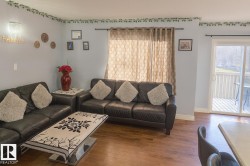 Living area featuring hardwood / wood-style flooring and baseboards - 