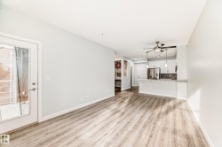 Unfurnished living room with light wood-type flooring and ceiling fan - 