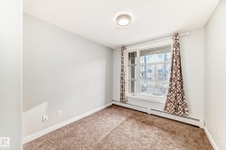 Unfurnished room with a baseboard radiator and carpet flooring - 