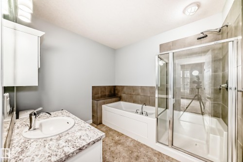 Full bathroom featuring vanity, a garden tub, and a stall shower - 201 2588 Anderson Way, Edmonton, AB - Indoor Photo Showing Bathroom