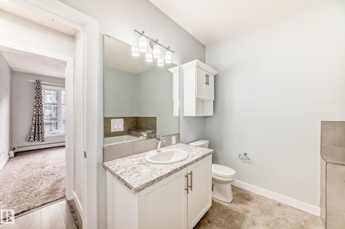 Bathroom with vanity and a baseboard radiator - 201 2588 Anderson Way, Edmonton, AB - Indoor Photo Showing Bathroom