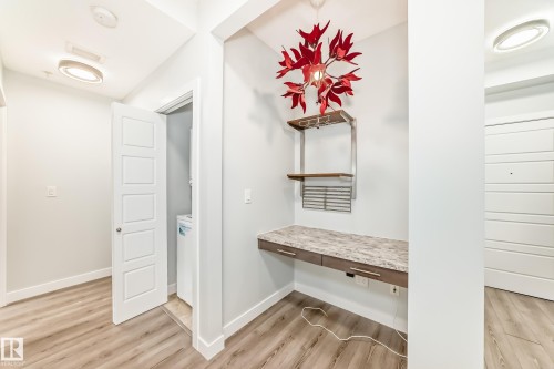 Corridor featuring light wood-type flooring and an office area - 201 2588 Anderson Way, Edmonton, AB - Indoor Photo Showing Other Room