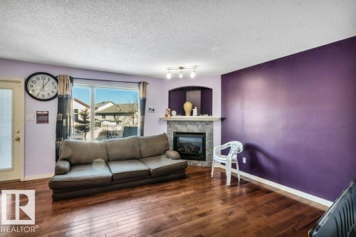 2144 37B Avenue, Edmonton, AB - Indoor Photo Showing Living Room With Fireplace