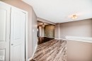 Corridor with light wood-style flooring and a textured ceiling - 9332 211 Street Nw, Edmonton, AB  - Indoor Photo Showing Other Room 