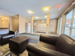 Community lobby featuring a textured ceiling - 