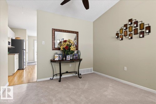 Spare room with ceiling fan, light colored carpet, and a textured ceiling - 13217 155 Avenue Nw, Edmonton, AB - Indoor Photo Showing Other Room
