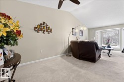 Carpeted living area with baseboards and ceiling fan - 