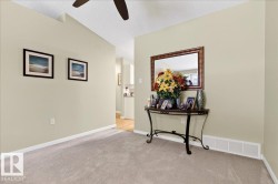 Hall with carpet flooring and a textured ceiling - 