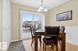 Dining space with wood finished floors and suspended lighting - 
