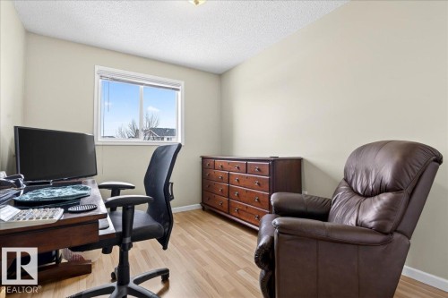 Office area featuring light wood-style flooring and a textured ceiling - 13217 155 Avenue Nw, Edmonton, AB - Indoor Photo Showing Office