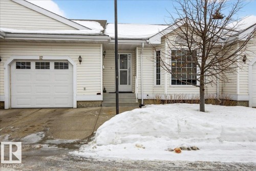 View of front of home featuring an attached garage and driveway - 13217 155 Avenue Nw, Edmonton, AB - Outdoor