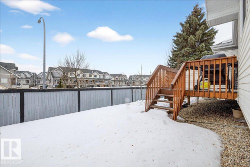 Fenced yard featuring a residential view and a deck - 13217 155 Avenue Nw, Edmonton, AB - Outdoor