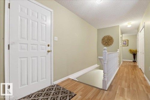Foyer entrance with wood finished floors and a textured ceiling - 13217 155 Avenue Nw, Edmonton, AB - Indoor Photo Showing Other Room
