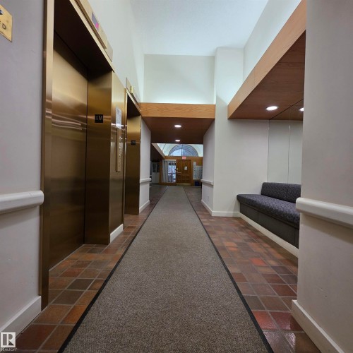 Hall with elevator, dark carpet, recessed lighting, and dark stone finish floors - 2C 10050 118 Street, Edmonton, AB - Indoor Photo Showing Other Room