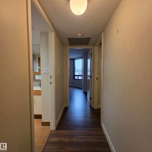 Hall with a textured ceiling and dark wood-style flooring - 2C 10050 118 Street, Edmonton, AB - Indoor Photo Showing Other Room