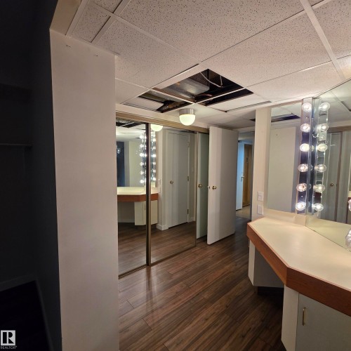 Bathroom featuring vanity, a paneled ceiling, and dark wood-style flooring - 2C 10050 118 Street, Edmonton, AB - Indoor Photo Showing Other Room