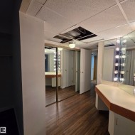 Bathroom featuring vanity, a paneled ceiling, and dark wood-style flooring - 