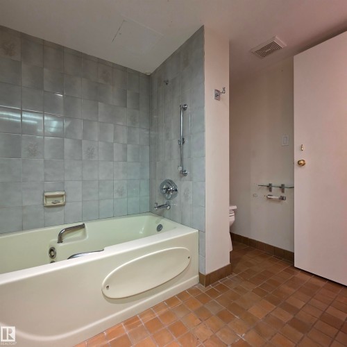 Bathroom featuring shower / bath combination and tile patterned floors - 2C 10050 118 Street, Edmonton, AB - Indoor Photo Showing Bathroom