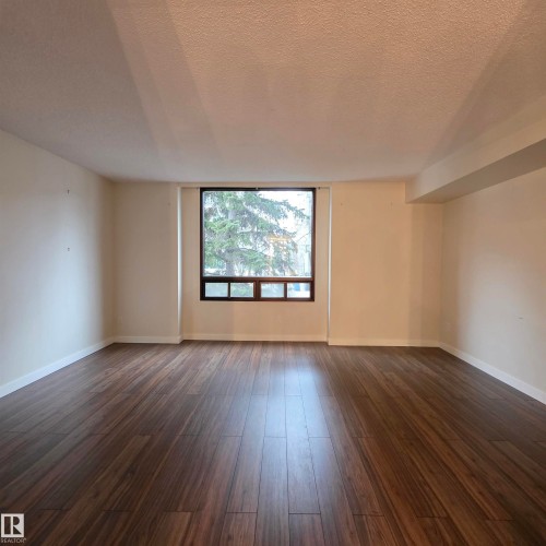 Spare room with a textured ceiling and dark wood-style flooring - 2C 10050 118 Street, Edmonton, AB - Indoor Photo Showing Other Room