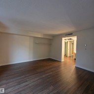 Unfurnished room featuring dark wood finished floors and a textured ceiling - 
