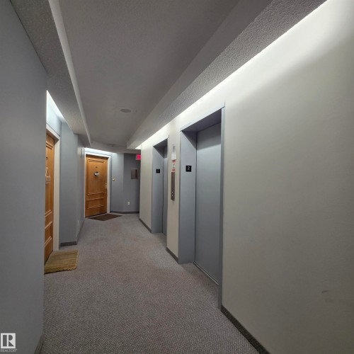 Hall featuring elevator and carpet flooring - 2C 10050 118 Street, Edmonton, AB - Indoor Photo Showing Other Room