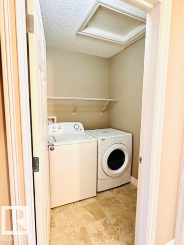 Laundry area with a textured ceiling and separate washer and dryer - 12219 167A Avenue, Edmonton, AB - Indoor Photo Showing Laundry Room