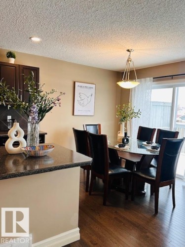 Dining room featuring dark wood-type flooring and a textured ceiling - 12219 167A Avenue, Edmonton, AB - Indoor Photo Showing Dining Room