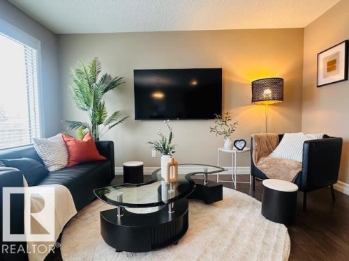 Living area with wood finished floors and a textured ceiling - 12219 167A Avenue, Edmonton, AB - Indoor Photo Showing Living Room