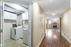 Laundry area with cabinet space, washer / clothes dryer, and a stone fireplace - 