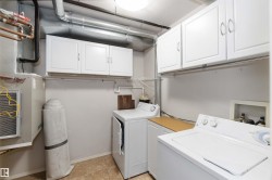 Laundry area featuring independent washer and dryer and cabinet space - 