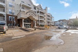 View of apartment building / complex featuring uncovered parking - 