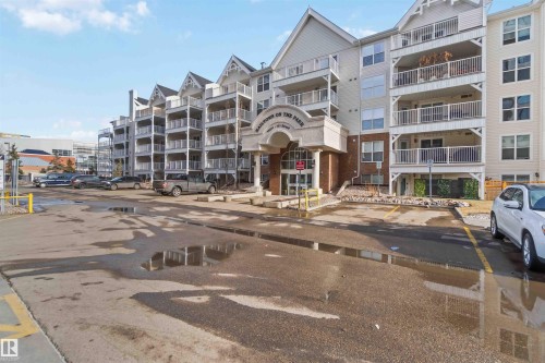 View of apartment building / complex featuring uncovered parking - 113 10311 111 Street, Edmonton, AB - Outdoor With Facade