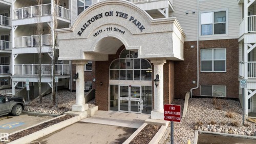 Property entrance with brick siding - 113 10311 111 Street, Edmonton, AB - Outdoor With Facade