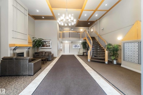 Common area with recessed lighting and high coffered ceiling - 113 10311 111 Street, Edmonton, AB - Indoor Photo Showing Other Room