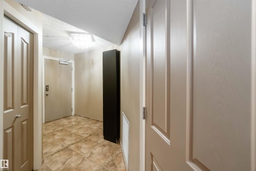 Corridor with a textured ceiling - 113 10311 111 Street, Edmonton, AB - Indoor Photo Showing Other Room
