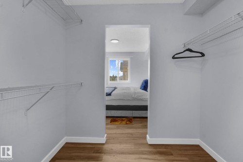 Walk in closet featuring light wood-style floors - 502 7511 171 Street Nw, Edmonton, AB - Indoor With Storage