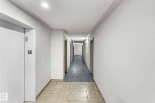 Corridor with elevator and baseboards - 502 7511 171 Street Nw, Edmonton, AB - Indoor Photo Showing Other Room