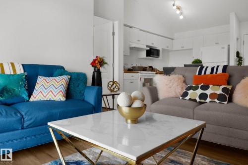 Living area featuring dark wood-style flooring and lofted ceiling - 502 7511 171 Street Nw, Edmonton, AB - Indoor Photo Showing Living Room