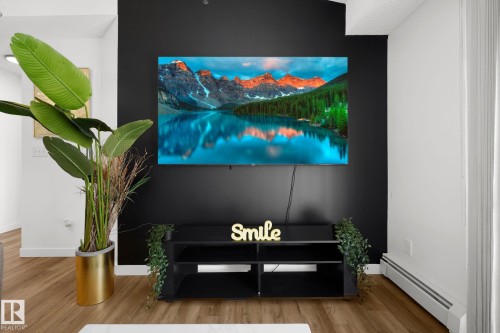 Detailed view of a baseboard heating unit and wood finished floors - 502 7511 171 Street Nw, Edmonton, AB - Indoor