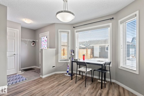 Dining space featuring a textured ceiling and light wood-type flooring - 3221 Cherry Cres Sw, Edmonton, AB - Indoor