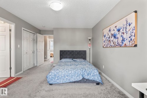 Bedroom featuring a textured ceiling and carpet floors - 3221 Cherry Cres Sw, Edmonton, AB - Indoor Photo Showing Bedroom