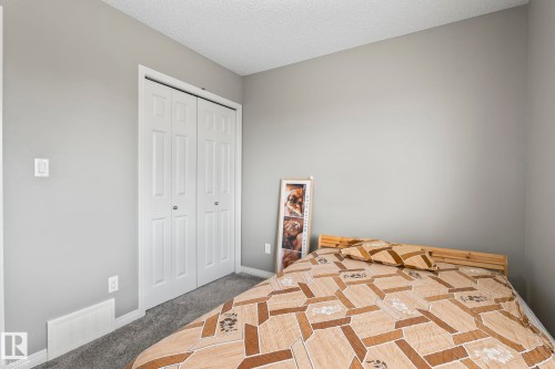 Unfurnished bedroom featuring a closet, a textured ceiling, and carpet floors - 3221 Cherry Cres Sw, Edmonton, AB - Indoor Photo Showing Bedroom