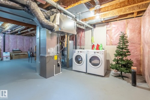 Unfinished below grade area with heating unit and washer and dryer - 3221 Cherry Cres Sw, Edmonton, AB - Indoor Photo Showing Laundry Room