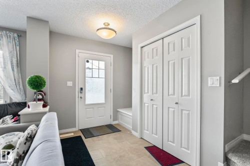 Entrance foyer with a textured ceiling and light tile patterned flooring - 3221 Cherry Cres Sw, Edmonton, AB - Indoor Photo Showing Other Room