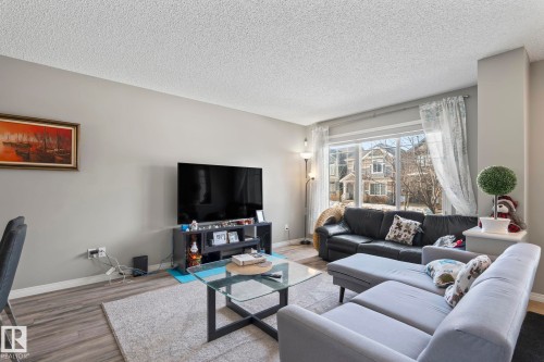 Living room with a textured ceiling and wood finished floors - 3221 Cherry Cres Sw, Edmonton, AB - Indoor Photo Showing Living Room